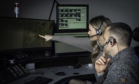 Two dispatchers in a training session sitting in front of computers